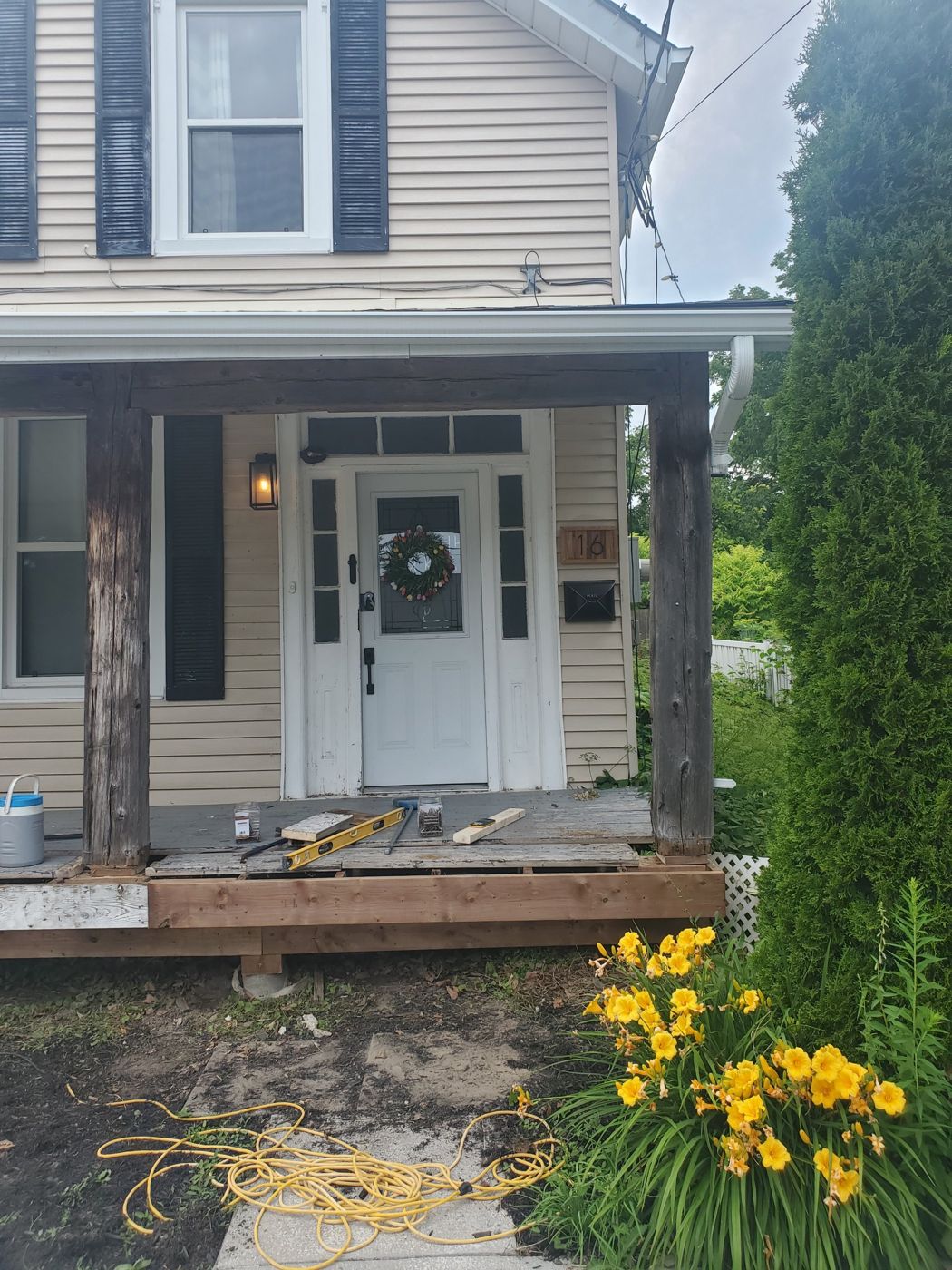 Front porch with new framing going in under the old posts